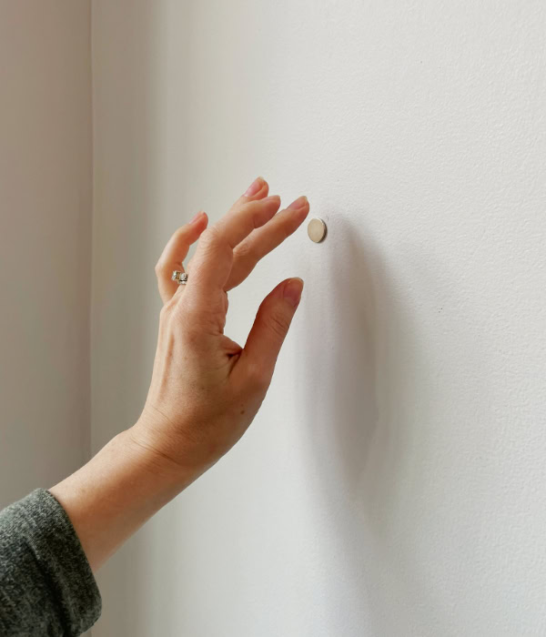 Using a magnet to find a stud behind drywall