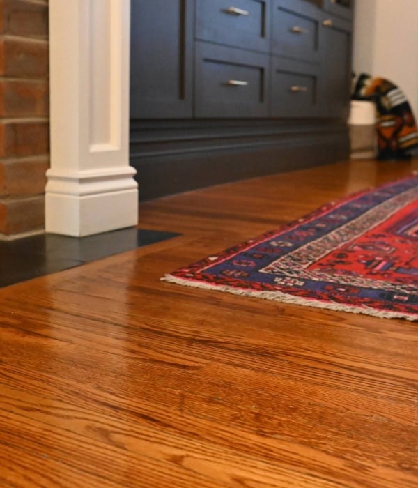 Close-up of shiny refinished old oak floor, but with a scratch that couldn't be sanded out (the scratch adds character).