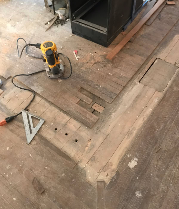 Large patch of missing flooring in old hardwood floors